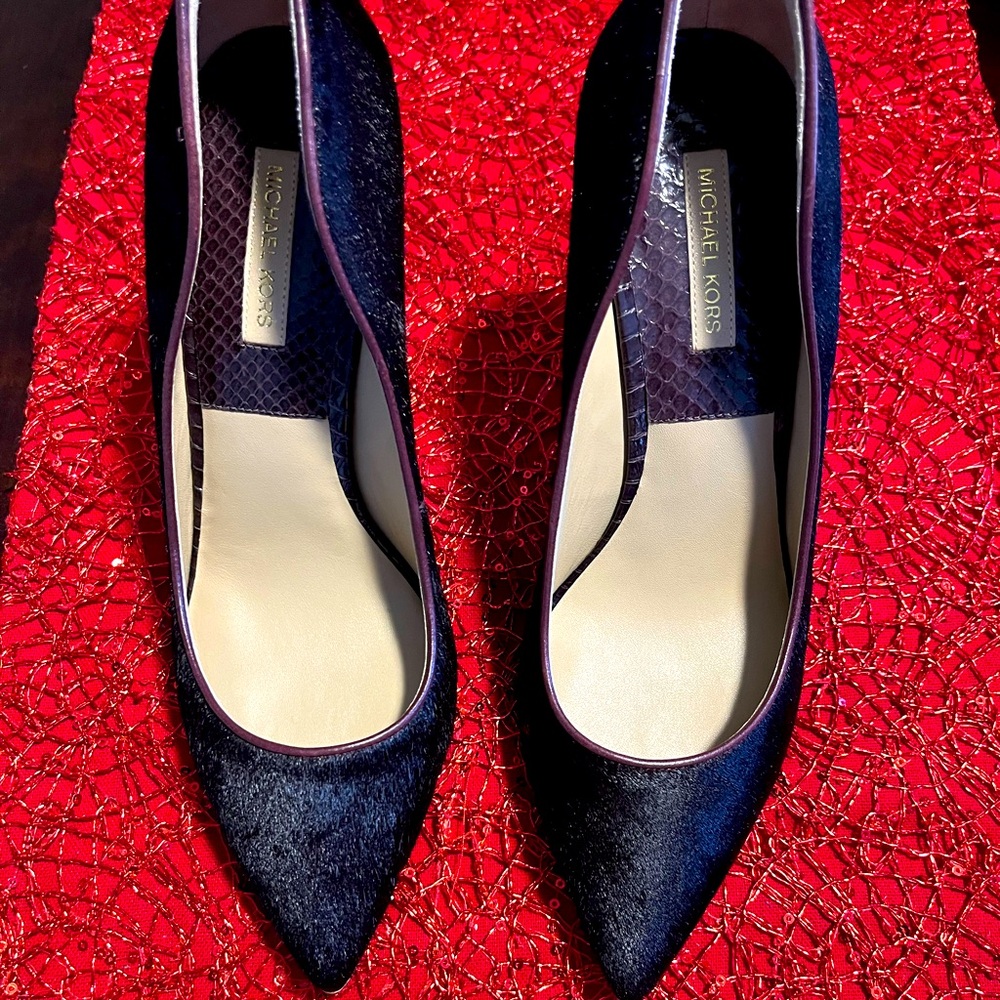 These Michael Kors pumps are a stunner.  She is adorn in brown calf hair.